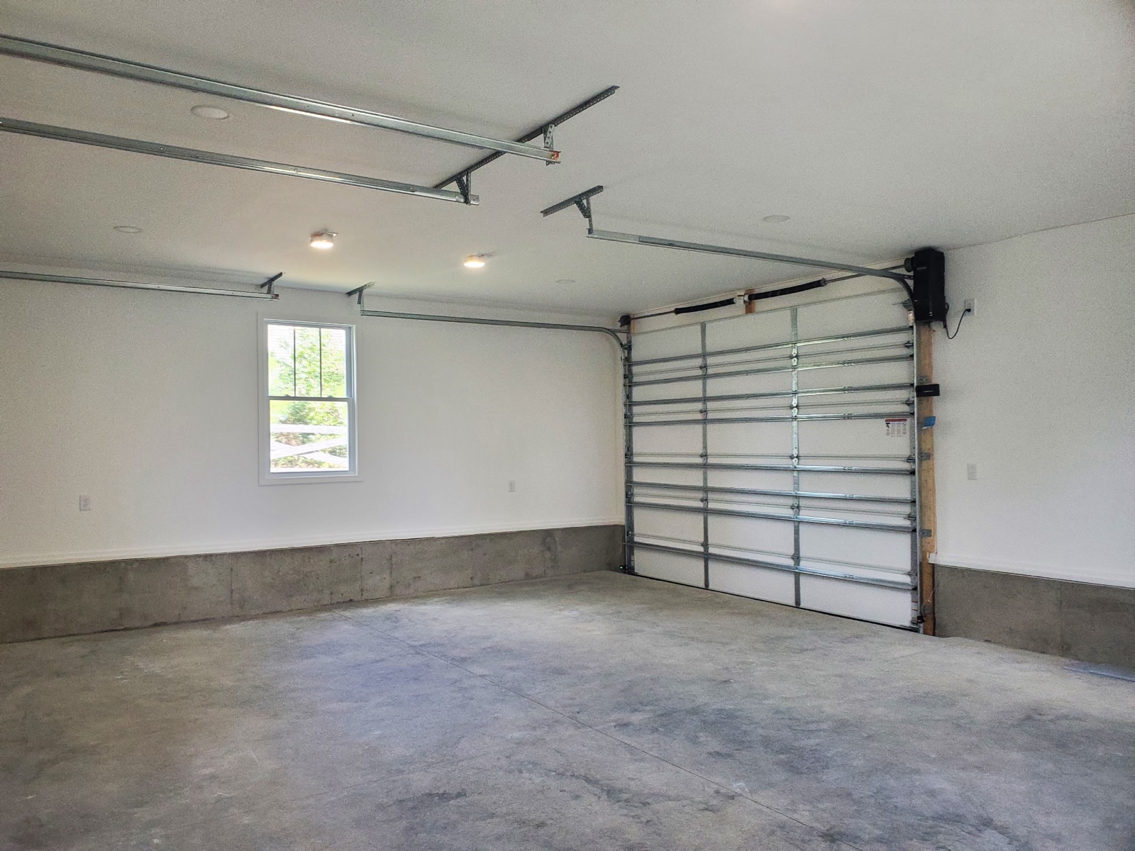 Finished garage interior with drywall and window - Bradie's Custom Construction, Fredericksburg VA