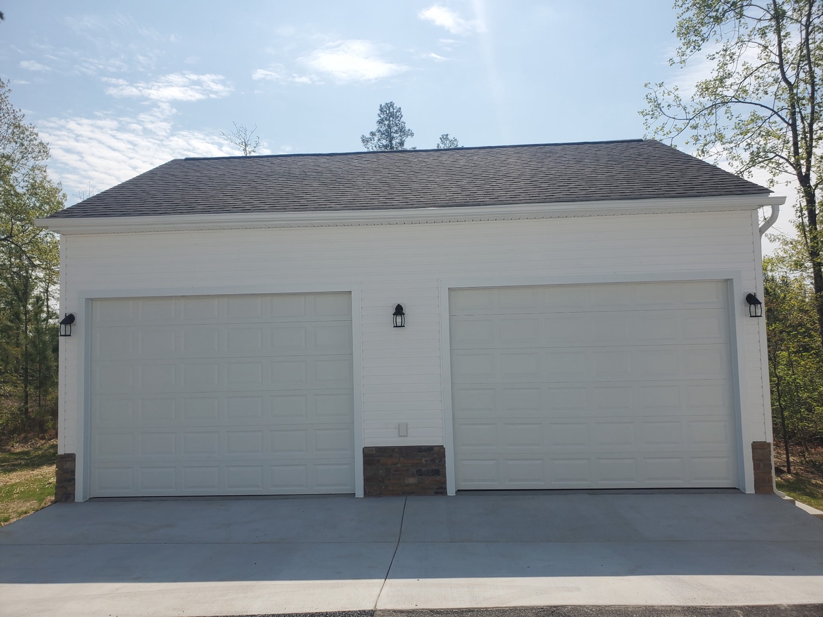 Two-car garage front with carriage lights and stone accents - Bradie's Custom Construction, Fredericksburg VA